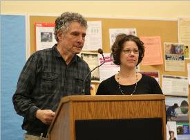 Poets Hal Sirowitz on the left and Minter Krotzer on the right stand at a podium.