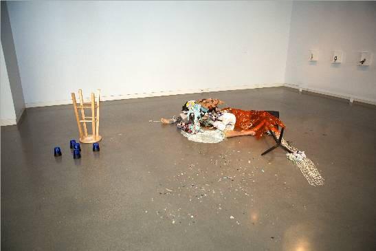 a brown floor against beige walls containing the objects described above