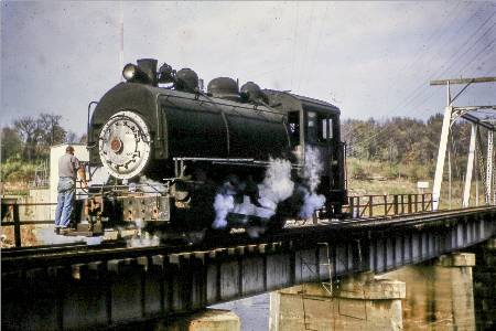 steam locomotive on a railway bridge over a river
